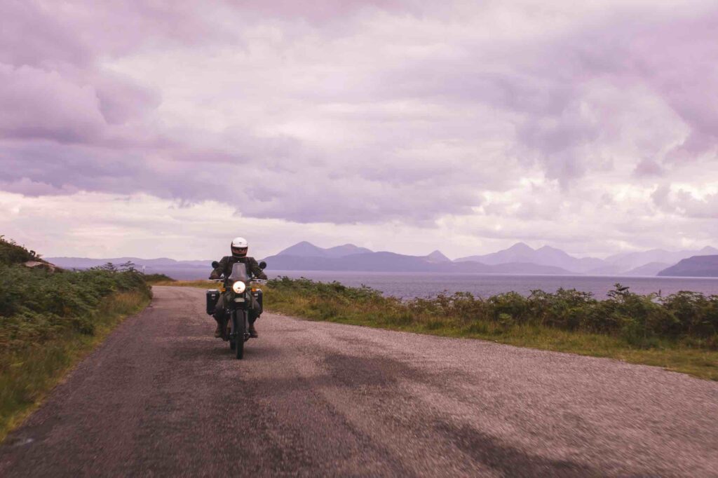 Motorcycling along the Applecross Peninsula with views over to Skye and the Cuillin Mountain Range