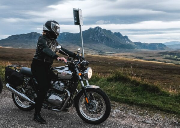 Female Motorcyclist riding through Scottish Highlands